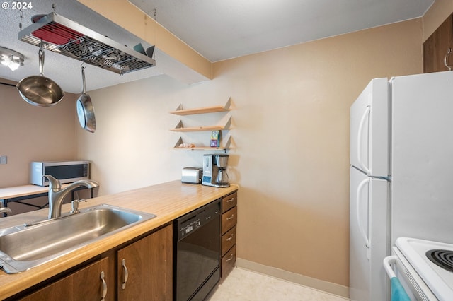 kitchen featuring sink, white fridge, and dishwasher