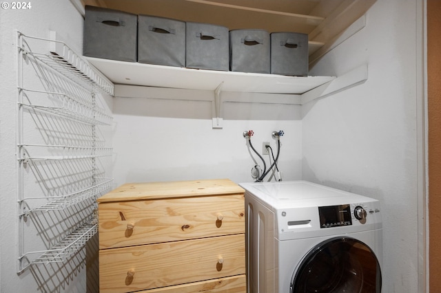 washroom featuring washer / clothes dryer and cabinets