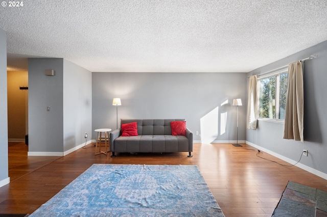 living room featuring a textured ceiling and hardwood / wood-style flooring