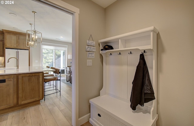 mudroom featuring sink and light hardwood / wood-style flooring