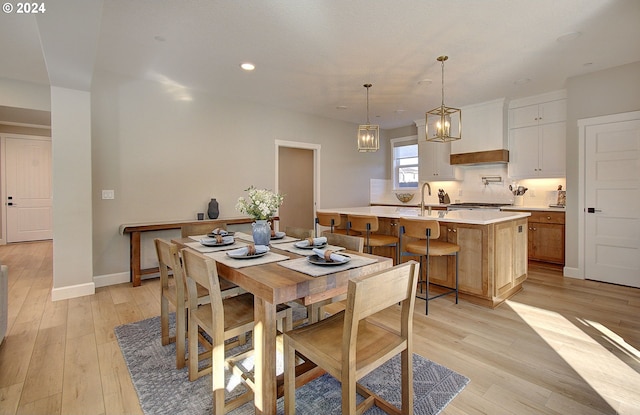 dining room with sink and light hardwood / wood-style flooring