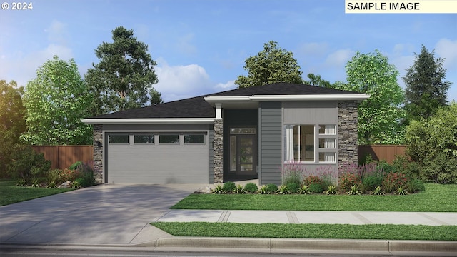 view of front of property featuring a front yard and a garage