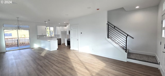 unfurnished living room featuring dark hardwood / wood-style floors and an inviting chandelier