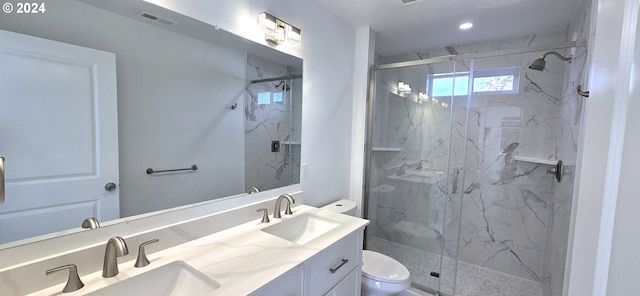 bathroom with vanity, toilet, and a shower with shower door