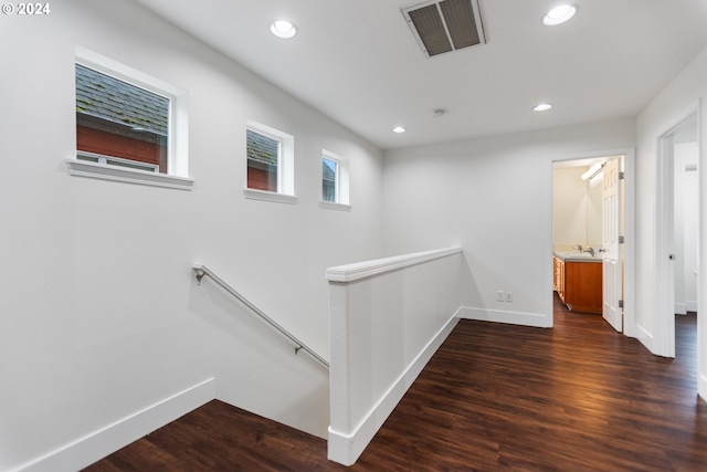 corridor featuring dark hardwood / wood-style flooring and sink