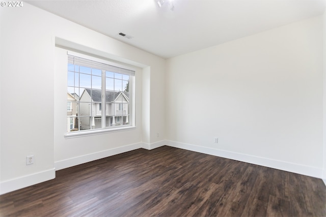 unfurnished room featuring dark wood-type flooring