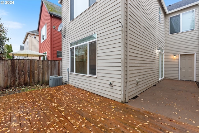 view of property exterior with a wooden deck and central AC