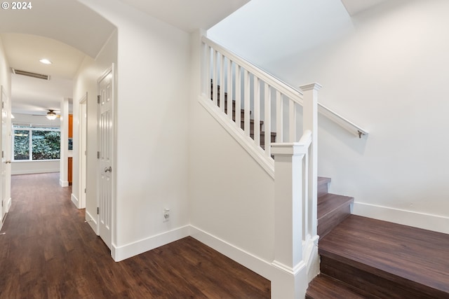 stairs featuring hardwood / wood-style flooring and ceiling fan