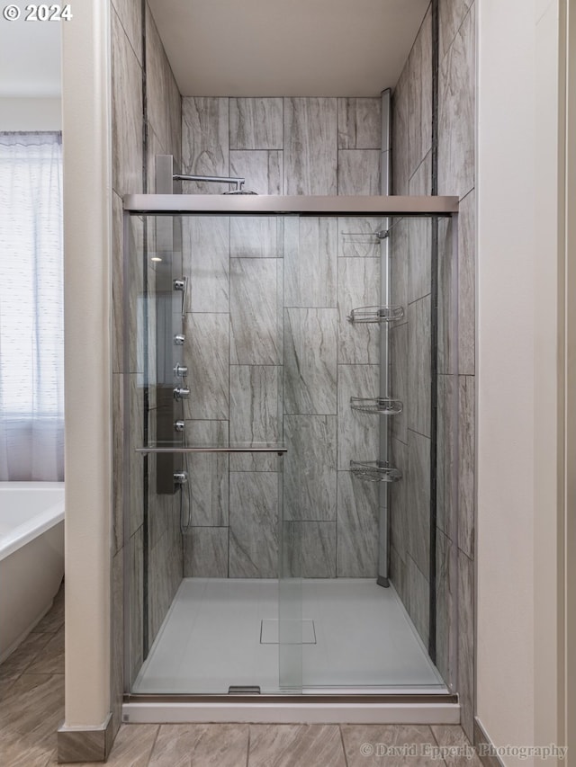 bathroom with separate shower and tub