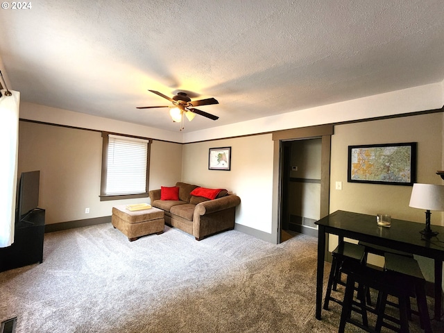 carpeted living room featuring a textured ceiling and ceiling fan