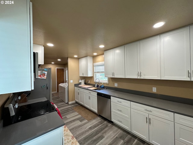 kitchen featuring dishwasher, white cabinetry, sink, and separate washer and dryer