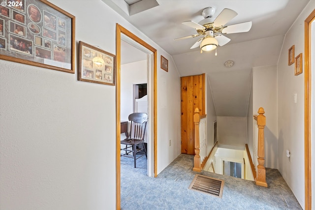 hall featuring light carpet and vaulted ceiling