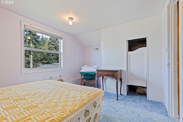 carpeted bedroom with lofted ceiling