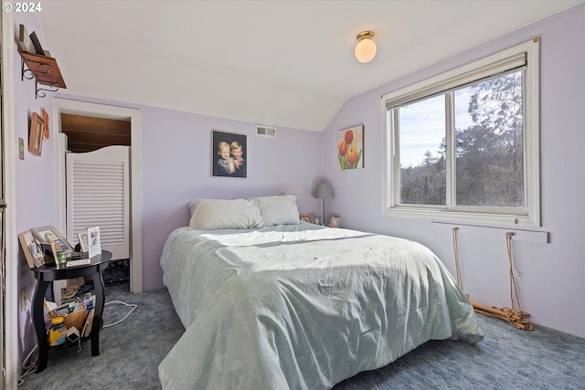 bedroom with carpet floors and vaulted ceiling