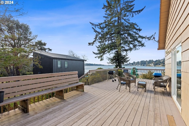 wooden deck featuring a water view