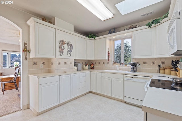 3770 NE 12th St, Otis, OR 97368 - kitchen with visible vents, white appliances, a sink, a wealth of natural light, and a skylight