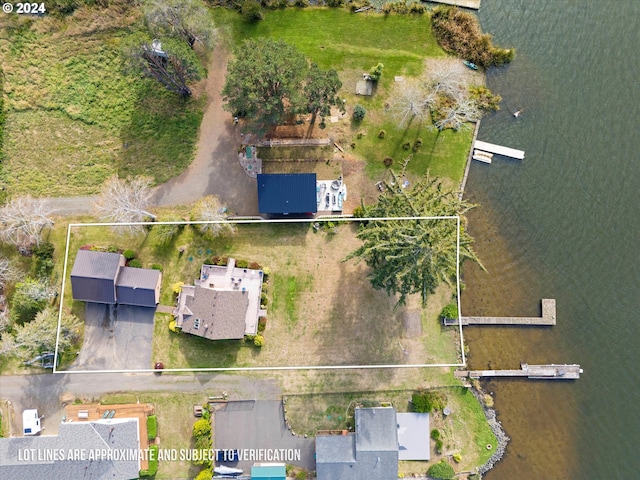 birds eye view of property with a water view