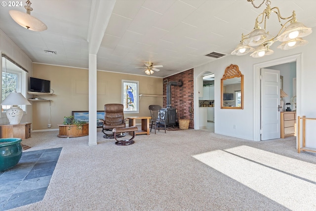 3770 NE 12th St, Otis, OR 97368 - living room featuring visible vents, arched walkways, a wood stove, carpet floors, and ceiling fan with notable chandelier