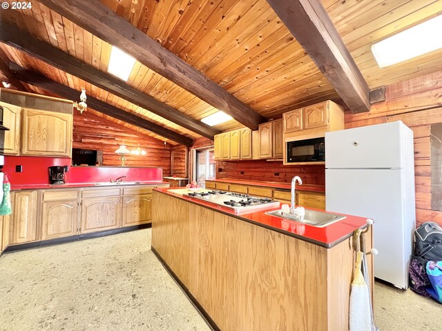 kitchen with lofted ceiling with beams, white appliances, kitchen peninsula, and sink