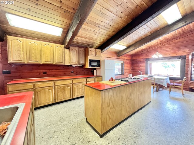 kitchen with vaulted ceiling with beams, hanging light fixtures, white appliances, wooden ceiling, and a center island