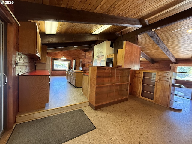 530 Riverside Dr, Burns, OR 97720 - kitchen featuring wood walls, plenty of natural light, brown cabinetry, and wooden ceiling