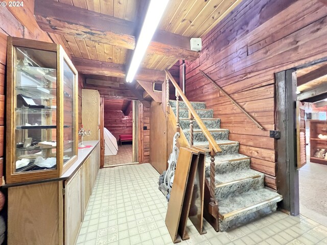 bathroom featuring a bathtub, beam ceiling, and wooden ceiling