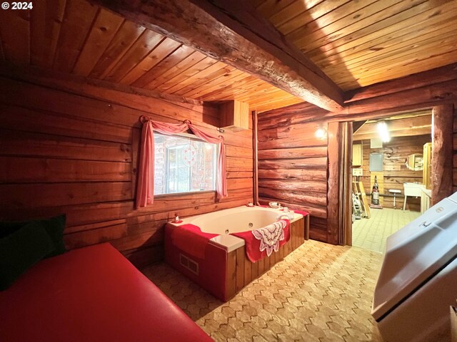 kitchen with beam ceiling, wood walls, light brown cabinets, and sink