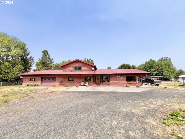 530 Riverside Dr, Burns, OR 97720 - view of front of property with an attached garage, driveway, and metal roof