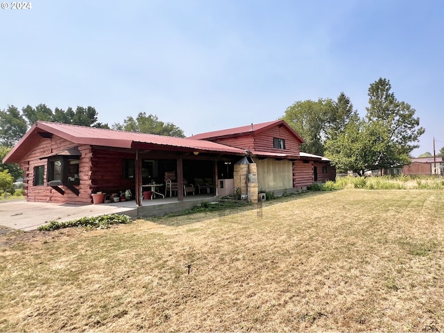 530 Riverside Dr, Burns, OR 97720 - back of house featuring log exterior, a patio, a yard, and metal roof
