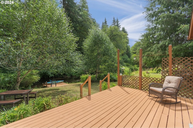 wooden deck featuring a yard