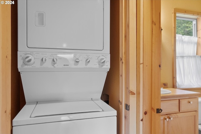 laundry room with stacked washer and clothes dryer