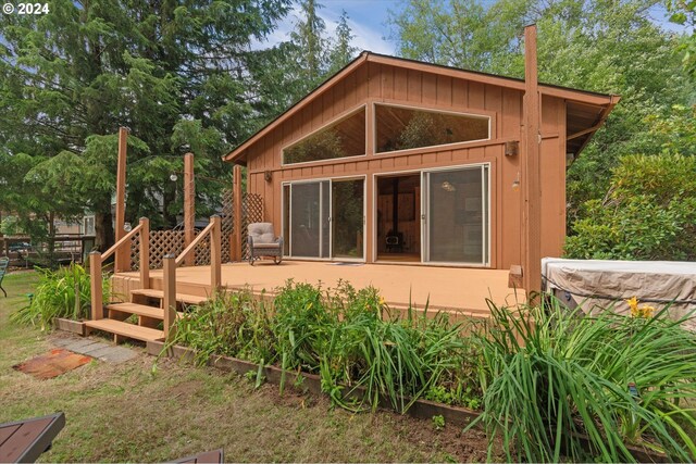 rear view of property featuring a deck