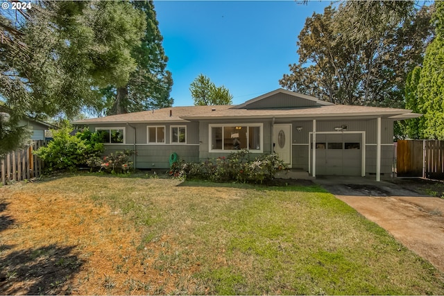 ranch-style home featuring a garage and a front lawn