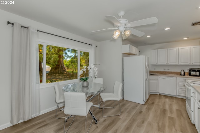 dining room with ceiling fan and light hardwood / wood-style flooring