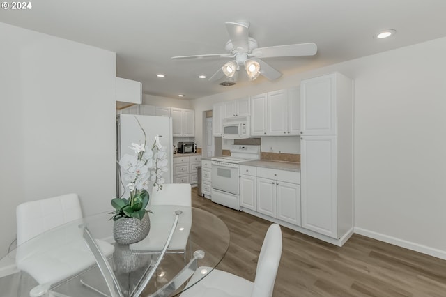 kitchen with white cabinetry, white appliances, wood-type flooring, and ceiling fan