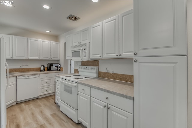 kitchen featuring light hardwood / wood-style flooring, white cabinets, and white appliances