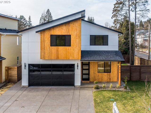 contemporary house featuring a garage and a front yard