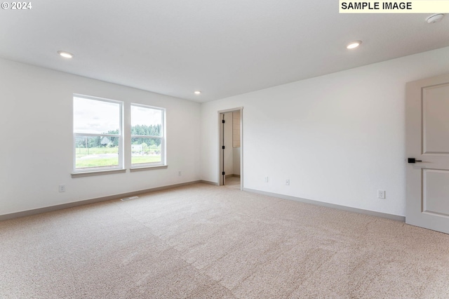 spare room with light colored carpet