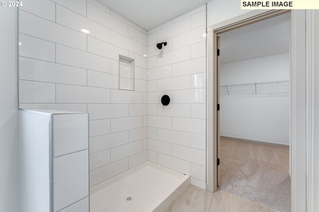 bathroom with tiled shower