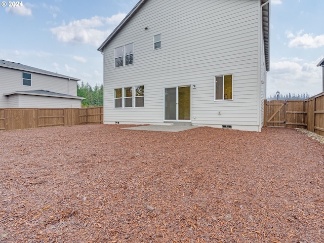 back of property with a patio