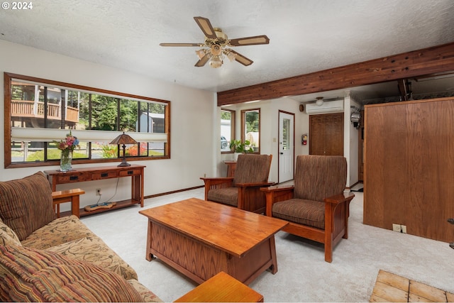 carpeted living room with ceiling fan, a wall mounted AC, and a textured ceiling