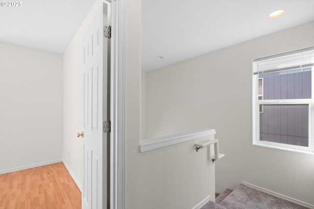 corridor with light hardwood / wood-style flooring