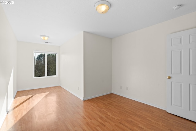 spare room with light wood-type flooring