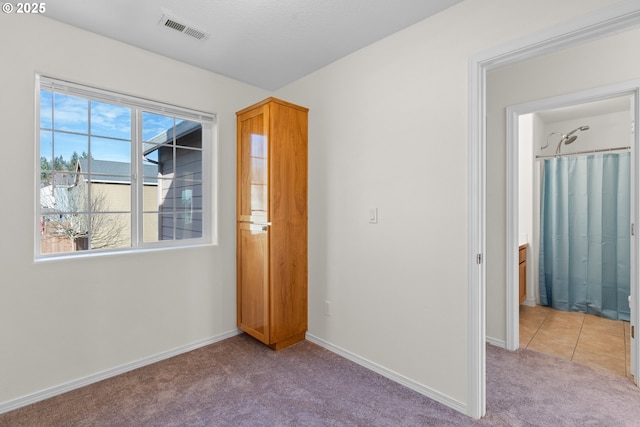 unfurnished bedroom featuring light colored carpet