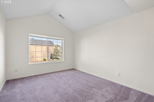 spare room featuring lofted ceiling and carpet flooring