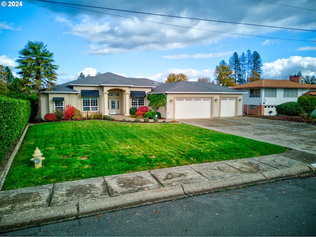 view of front of property featuring a front lawn and a garage