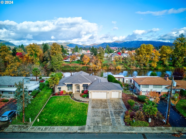 birds eye view of property featuring a water and mountain view