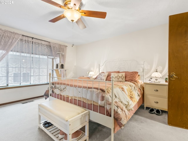 bedroom featuring visible vents, ceiling fan, light carpet, and baseboards