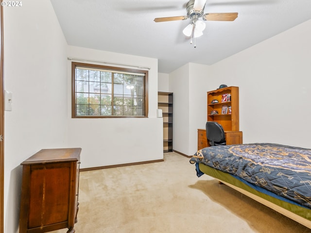 bedroom featuring light carpet, ceiling fan, and baseboards