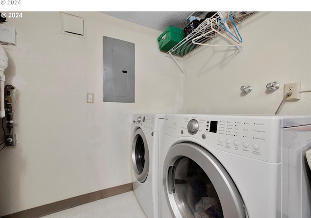 clothes washing area featuring washing machine and clothes dryer, mail area, laundry area, electric panel, and baseboards